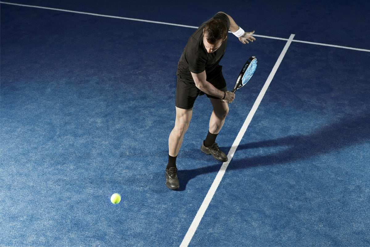 Stock placeholder: player holding a padel racket on court