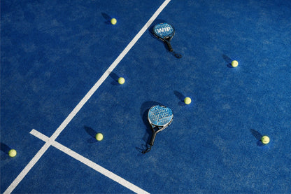 Stock placeholder: two padel rackets and balls on a blue court