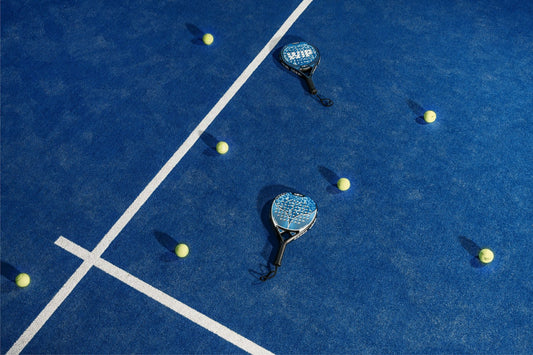 Stock placeholder: two padel rackets and balls on court